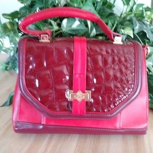 A Vera Wang Bag in red and maroon man made materi